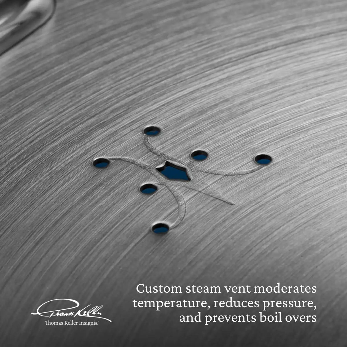 Close-up of a metal surface with steam vent holes. Text: Custom steam vent moderates temperature, reduces pressure, and prevents boil overs in our Commercial Clad Stainless Steel 10-Piece Cookware Set. Thomas Keller Commercial Clad logo in the corner.