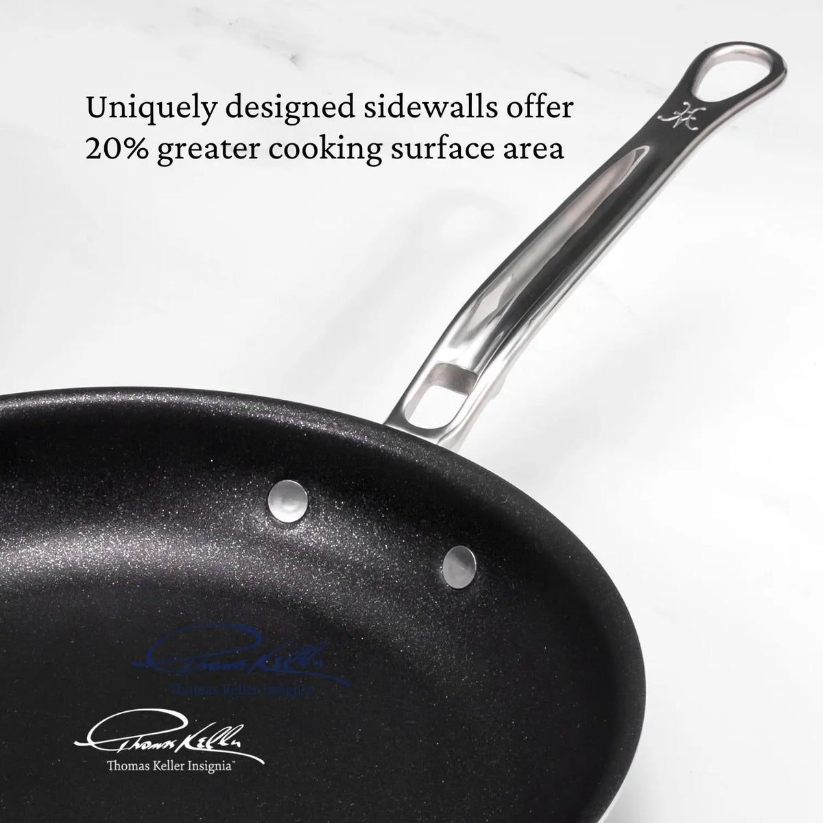 A Thomas Keller Commercial Clad Stainless Steel 11-Piece Cookware Set nonstick pan with a metal handle and embossed logo is shown on a white surface. Text: "Uniquely designed sidewalls offer 20% greater cooking surface area.