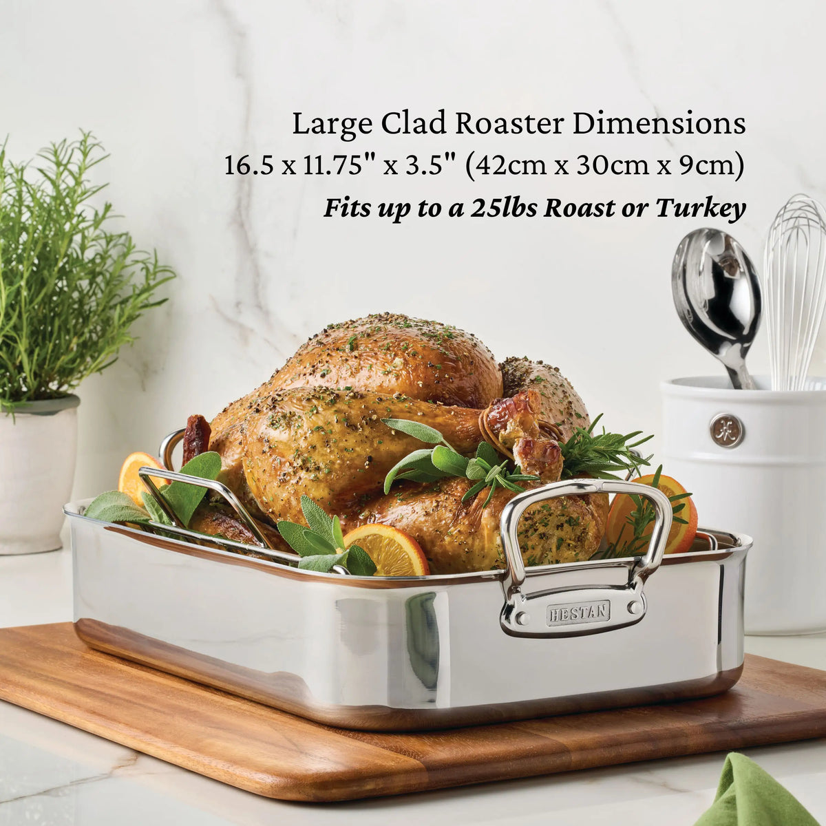 A beautifully presented large roasted turkey with herbs and lemon slices rests in a CopperBond Copper Induction Set roasting pan on a wooden board, accompanied by kitchen utensils and fresh herbs. Handcrafted in Italy, this 24-piece CopperBond cookware set elevates your kitchen with elegance and delivers outstanding performance. Text highlights the set’s dimensions and weight capacity.