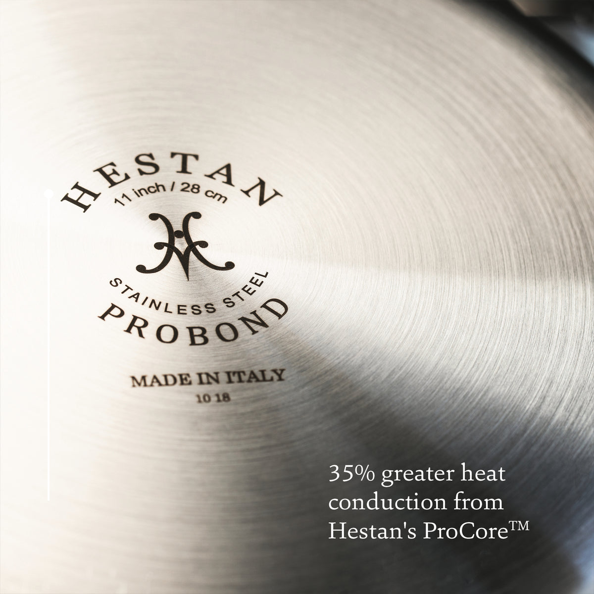 Close-up of stainless steel cookware surface featuring ProBond Professional Clad and MADE IN ITALY, measuring 11 inch / 28 cm. Notable for 35% greater heat conduction from Hestans ProCore™. Part of the Professional Clad Stainless Steel Epicurean Set, 15-piece by ProBond.