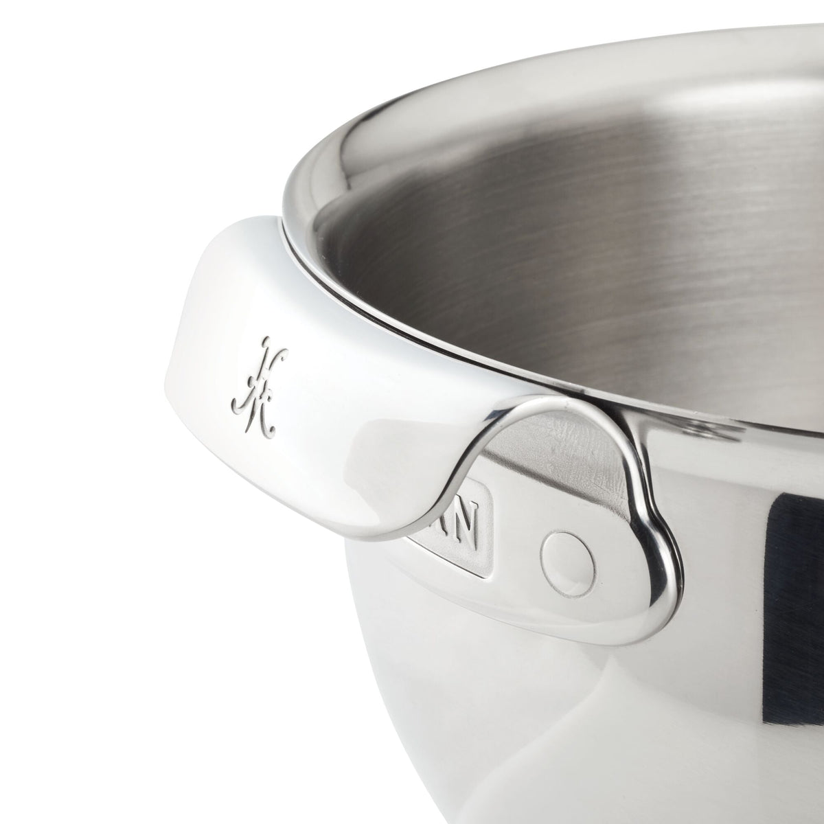 Close-up of Hestan Provisions 7-Quart Stainless Steel Mixing Bowl, showcasing its ergonomic handle with an engraved design and subtle grip indentation. The interior reveals a brushed metal finish.